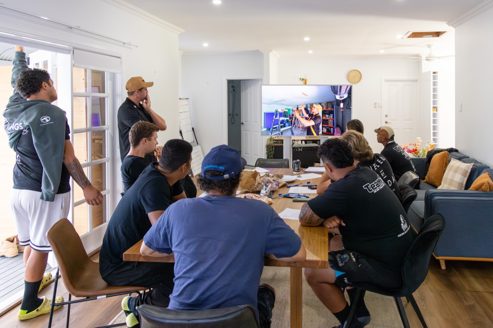 Tommy running a team meeting with his crew